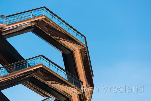 Upper railings of 'Vessel' on a cloudless summer day in New York City's Hudson Yards